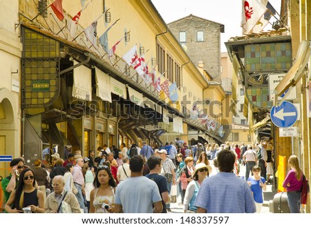 FLORENCE, ITALY - JUNE 6: tourists on the Ponte Vecchio on June 6, 2013 in Florence, Italy. The Ponte Vecchio is a medieval bridge, one of the most famous and popular tourist attractions in Florence.