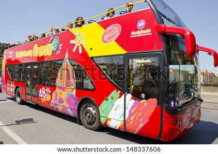 FLORENCE, ITALY - JUNE 6: a City Sightseeing bus on June 6, 2013 in Florence, Italy. City Sightseeing is a global sightseeing bus franchise which began in 2000 in Glasgow and Canberra.