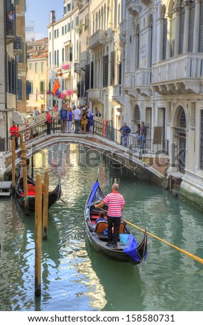 VENICE, ITALY - JUNE 6: a gondolier on June 6, 2013 in Venice, Italy. Venice is one of the world\'s most popular tourist destinations with 21 million visitors per annum.