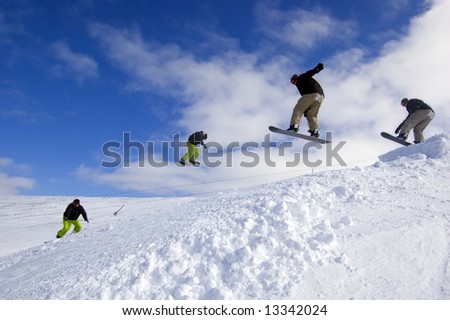 Snowboarders jumping - cool extreme sports action at Cairngorm Mountain in Scotland