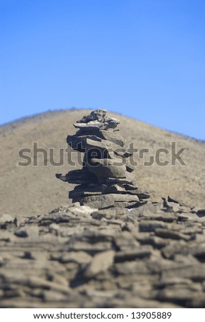 Cairn of rocks half way up a hill