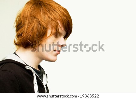 Young red haired man on light background