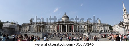 LONDON - MAY 25: Tourists enjoy a heatwave in Trafalgar Square on May 25th, 2009 in London, England. Trafalgar Square is at the geographical center of London.