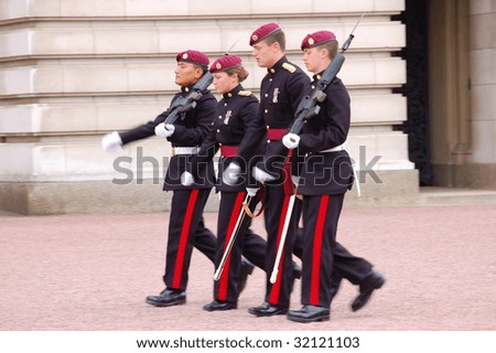LONDON - MAY 25: Soldiers march outside Buckingham Palace on May 25th, 2009 in London, England. Buckingham palace is the primary residence of Queen Elizabeth II.