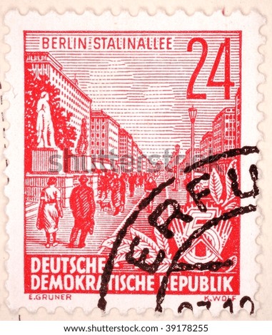EAST GERMANY - 1953: A 24 pfennig stamp (East Germany Scott 163A used) printed in East Germany shows image of the Stalin-Allee (also known as the Karl-Marx-Allee) in Berlin, series, circa 1953