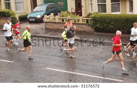 EDINBURGH - APRIL 18: Runners compete in the Edinburgh Chris Hoy Half Marathon, here going down Lochend Road, on April 18th, 2010 in Edinburgh, UK.