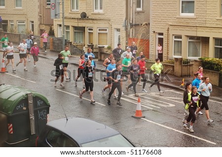EDINBURGH - APRIL 18: Runners compete in the Edinburgh Chris Hoy Half Marathon, here going down Lochend Road, on April 18th, 2010 in Edinburgh, UK.