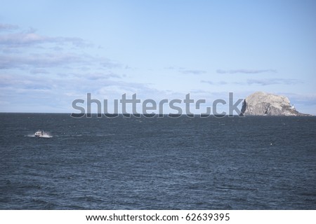 Bass Rock (world\'s largest single rock gannet colony) and fishing boat viewed from North Berwick - Scottish seascape