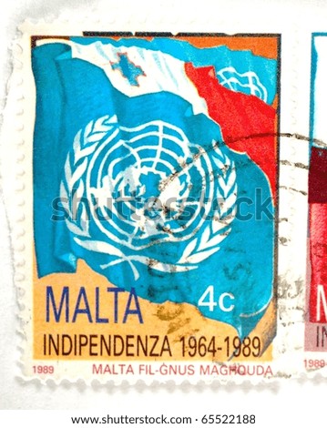 MALTA - CIRCA 1989: a stamp printed in Malta shows the UN logo and celebrates 25 years of Maltese independence, circa 1989