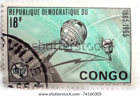 DEMOCRATIC REPUBLIC OF CONGO - CIRCA 1965: a black, light green and grey stamp from the Democratic Republic of Congo shows image of the Earth and satellites, circa 1965