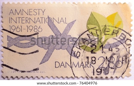 DENMARK - CIRCA 1986: A stamp from Denmark shows image commemorating the 25th birthday of Amnesty International, the human rights organisation, circa 1986