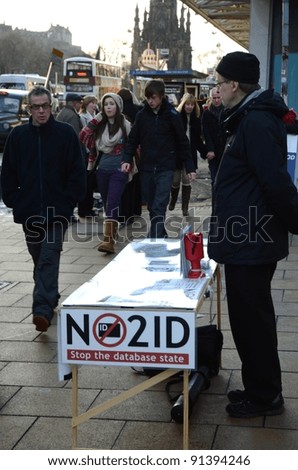 EDINBURGH - DECEMBER 17: a man offers passers by to sign a petition against ID cards on December 17, 2011 in Edinburgh, UK. ID cards could be issued to all UK citizens in the coming years.