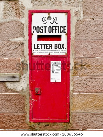 LUSS, SCOTLAND - DECEMBER 27: a Royal Mail post office letter box on December 27, 2013 in Luss, Scotland. Royal Mail was established in 1516 when King Henry VIII established a Masters of the Posts.