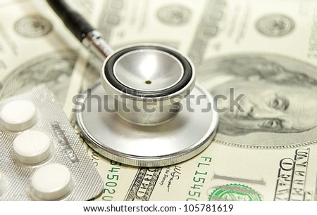 health care costs - Stethoscope on money background and pills