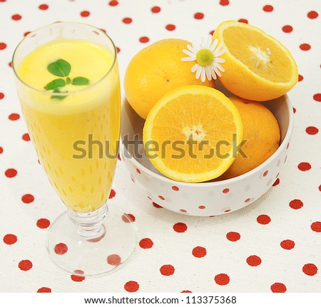 Fresh lemonade with mint leaves and sliced lemon,isolated on homey red dotted background