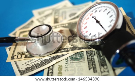 Blood pressure device and stethoscope  with money - high costs of expensive medication concept