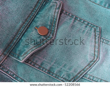 Closeup of green denim jeans pocket.