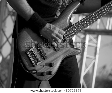 Man playing electrical guitar in black and white