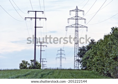 electricity pylons in the green field
