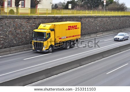 MAINZ, GERMANY - FEB 09: DHL delivery truck on the highway on February 09,2015 in Mainz, Germany. DHL is a world wide courier company that operates in 220 countries with over 285,000 employees.