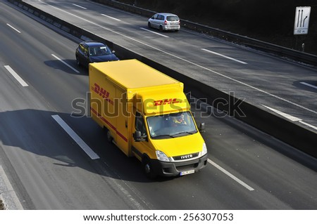 MAINZ, GERMANY - FEB 20: DHL delivery van on the highway on February 20, 2015 in Mainz, Germany. DHL is a world wide courier company that operates in 220 countries with over 285,000 employees.