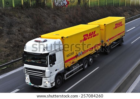 MAINZ, GERMANY - FEB 20: DHL delivery truck on the highway on February 20,2015 in Mainz, Germany. DHL is a world wide courier company that operates in 220 countries with over 285,000 employees.