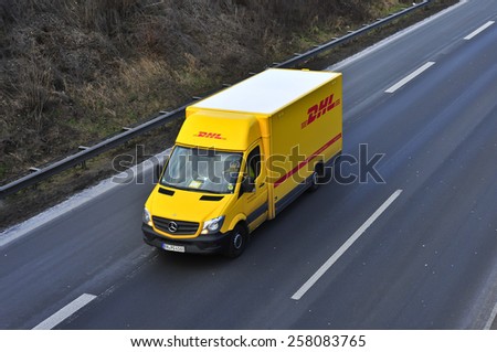 MAINZ, GERMANY - FEB 20: DHL delivery van on the highway on February 20,2015 in Mainz, Germany. DHL is a world wide courier company that operates in 220 countries with over 285,000 employees.