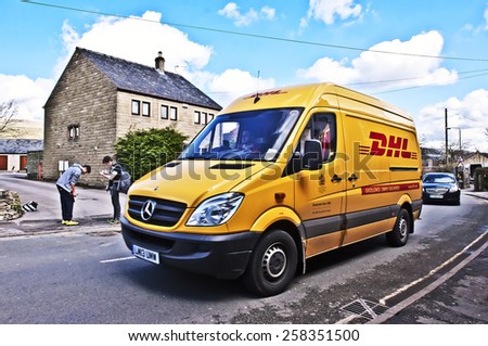 MANCHESTER,ENGLAND-APRIL 01: DHL delivery van on the street on April 01, 2014in Mainz, Germany. DHL is a world wide courier company that operates in 220 countries with over 285,000 employees.