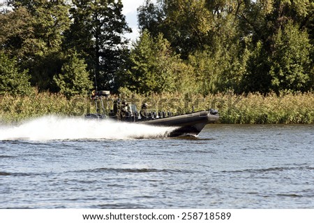 RUSNE,LITHUANIA_AUG 27:military boat patrolling in the river on August 27,2014 in Rusne,Lithuania.