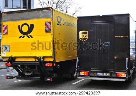 MAINZ, GERMANY - FEB 19: DEUTSCHE POST and UPS trucks in the street on February 19, 2015 in Mainz, Germany.