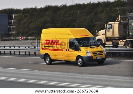 FRANKFURT,GERMANY - MARCH 28: DHL delivery van on the highway on March 28,2015 in Frankfurt, Germany. DHL is a world wide courier company that operates in 220 countries with over 285,000 employees.