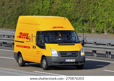 FRANKFURT,GERMANY - APRIL 10: DHL delivery van on the highway on April 10,2015 in Frankfurt, Germany. DHL is a world wide courier company that operates in 220 countries with over 285,000 employees.