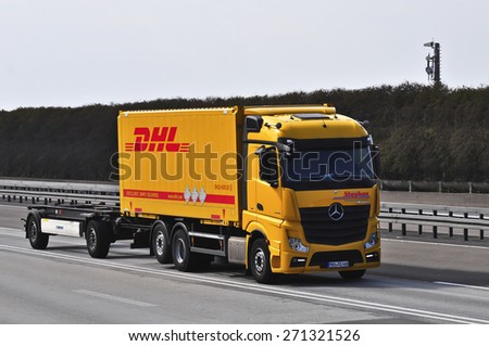 FRANKFURT,GERMANY - MARCH 28: DHL delivery truck on the highway on March 28,2015 in Frankfurt, Germany. DHL is a world wide courier company that operates in 220 countries with over 285,000 employees.