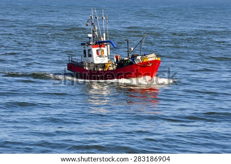 KLAIPEDA,LITHUANIA- MAY 28: red fishing boat in Baltic Sea on May 28,2015 in Klaipeda,Lithuania.