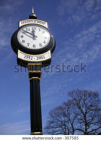 old fashioned style clock against a blue sky