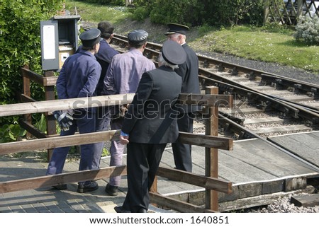 railway men watching the train as it changes track