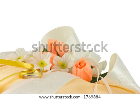 stock photo wedding ring on a cushion with flowers and ribbons