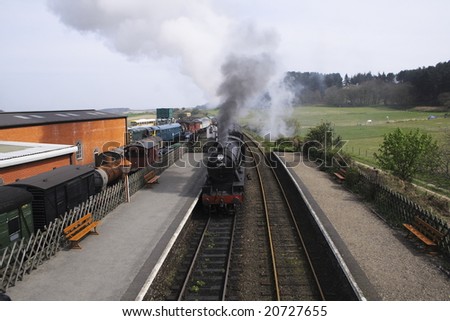 tourism locomotive entering a station where old locomotives are restored