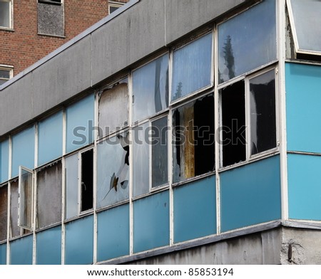 derelict building  with smashed window left just to drop into decay