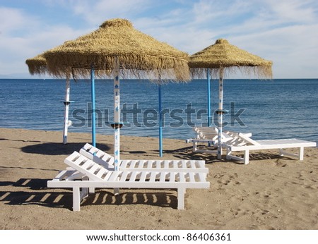 sunbeds and parasols set out on a sandy beach