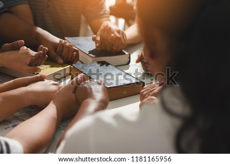 Group of people holding hands praying worship believe. Christian holding hand and praying.devotional or prayer meeting concept.