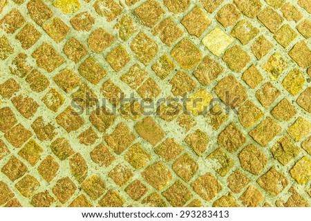 Coloured stone background on the basis of natural material. Sidewalk, paved with granite elements.