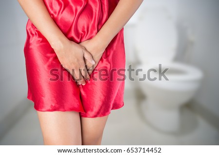 Woman with hands holding pressing her crotch lower abdomen. Medical or gynecological problems, Healthcare concept