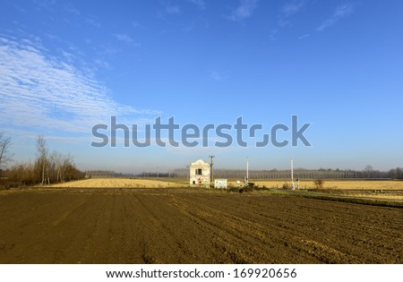 Rail crossing with house in autumn, Lomellina (North Italy)