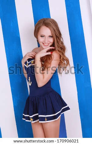 oung beautiful sailor woman on the white and blue background