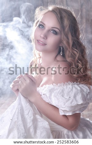 tender bride in white retro dress on smoke background