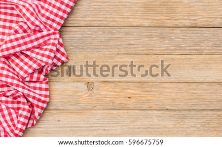 Table cloth red on wood background, top view, copyspace.
