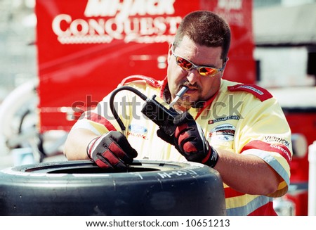 Car racing crew member checking tires - EDITORIAL
