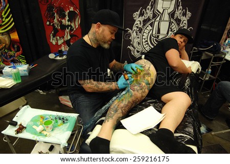 VANCOUVER, CANADA - APRIL 25, 2014: An artist is working on a tattoo at the 2014 Vancouver Tattoo and Culture Show in Vancouver, Canada, on April 25, 2014.
