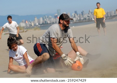 VANCOUVER, CANADA - AUGUST 12, 2012: Athletes battle during the 16th annual Umbro Beach Soccer Blast tournament in Vancouver, Canada, on August 12, 2012.